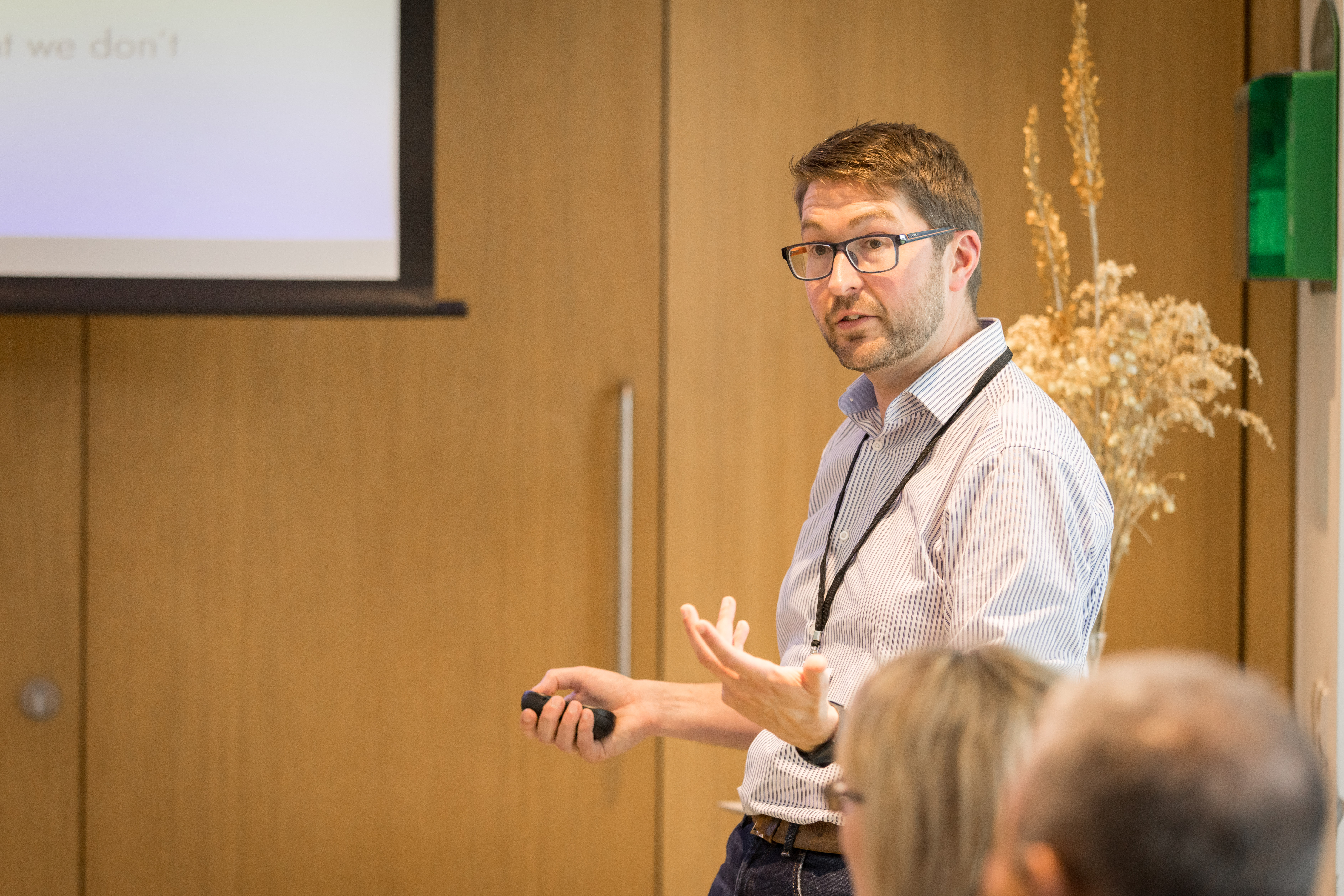 A photo of Mark Symes presenting at an event.